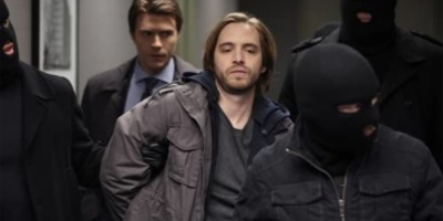 Birkhoff (played by Aaron Stanford) being brought to a CIA interrogation room by Ryan's (played by Noah Bean) team