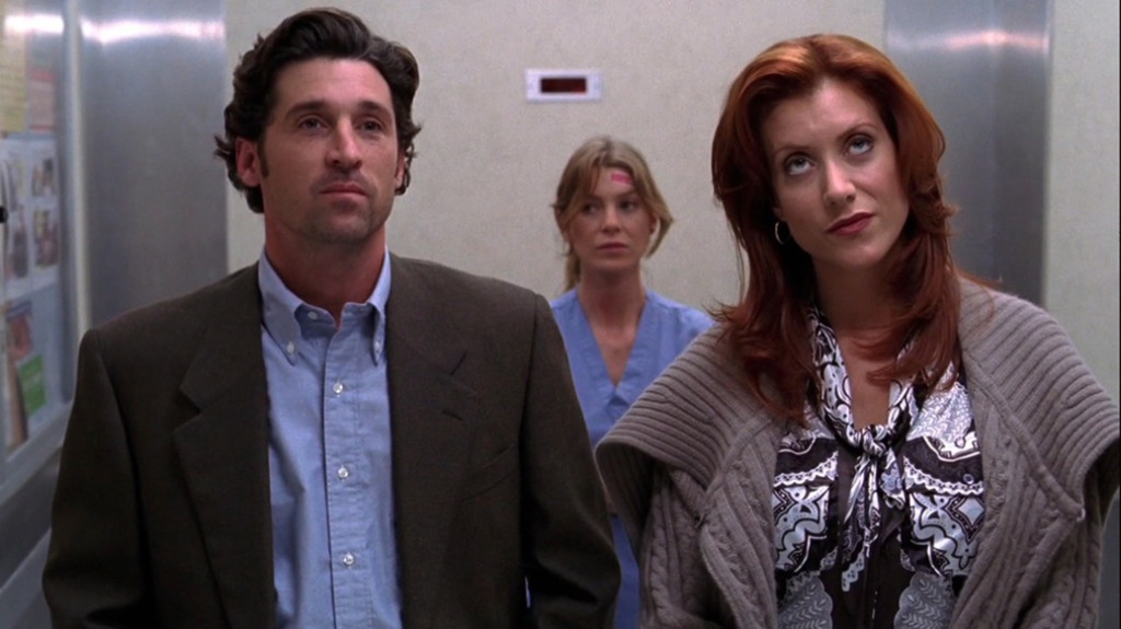 Still of Derek (played by Patrick Dempsey), Addison (played by Kate Walsh), who's rolling her eyes, and Meredith (played by Ellen Pompeo) in an elevator from Grey's Anatomy 2x08