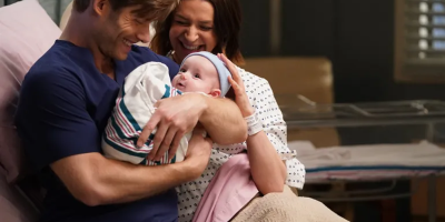 Still of Link (played by Chris Carmack) holding baby Scout in his arms and Amelia (played by Caterina Scorsone) in Amelia's hospital bed after giving birth from Grey's Anatomy 16x21