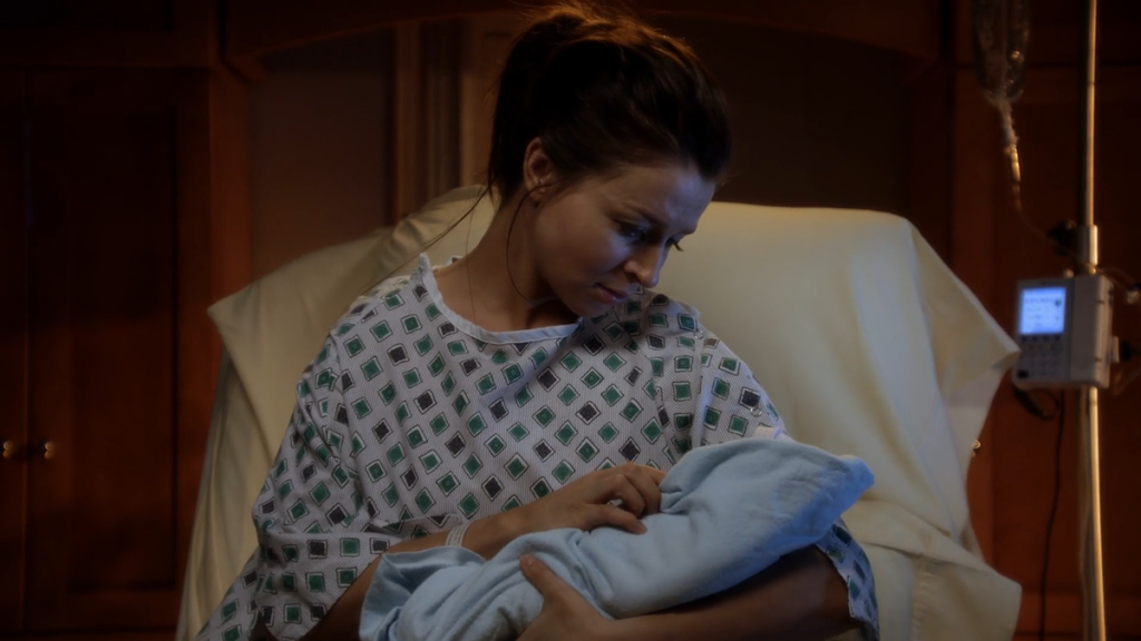 Still of Amelia (played by Caterina Scorsone) holding her unicorn baby from Private Practice 5x22